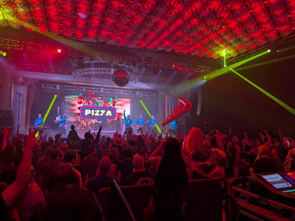 Aquabats concert, inflatable slices of pizza being bounced around 