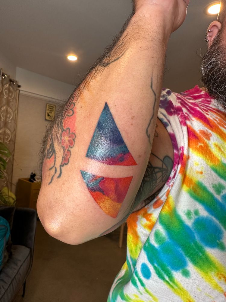 Abstract tattoo with lots of color in shape of triangles 