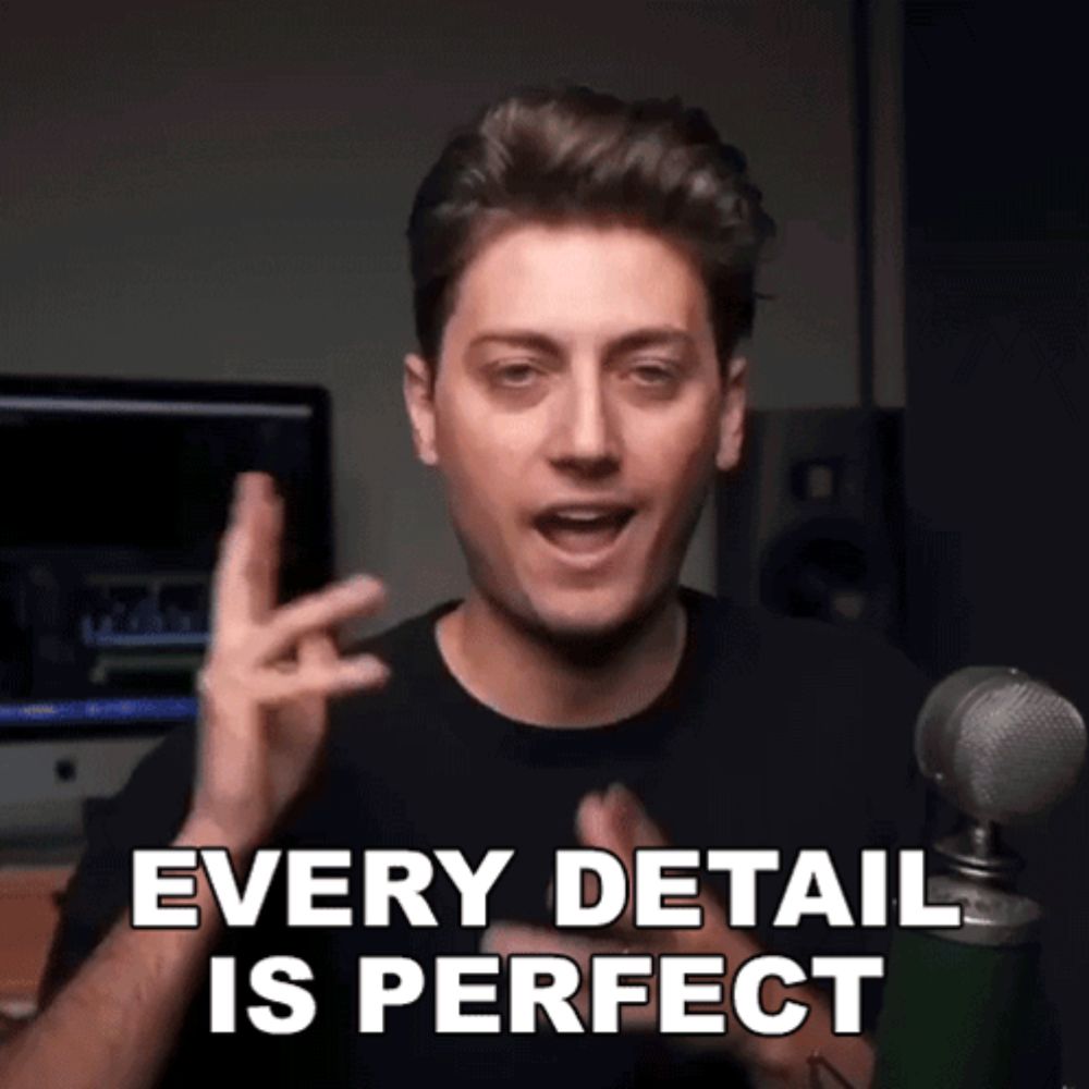 a man in front of a microphone is saying every detail is perfect