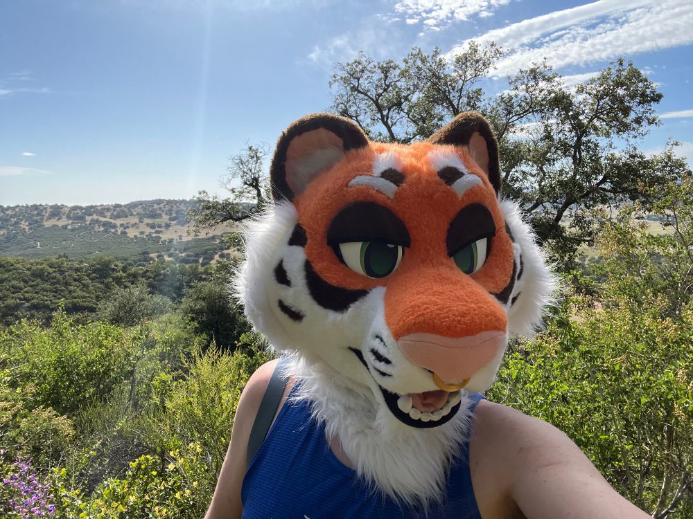 Rowan on a hike taking a selfie capturing the flora and scenery behind him