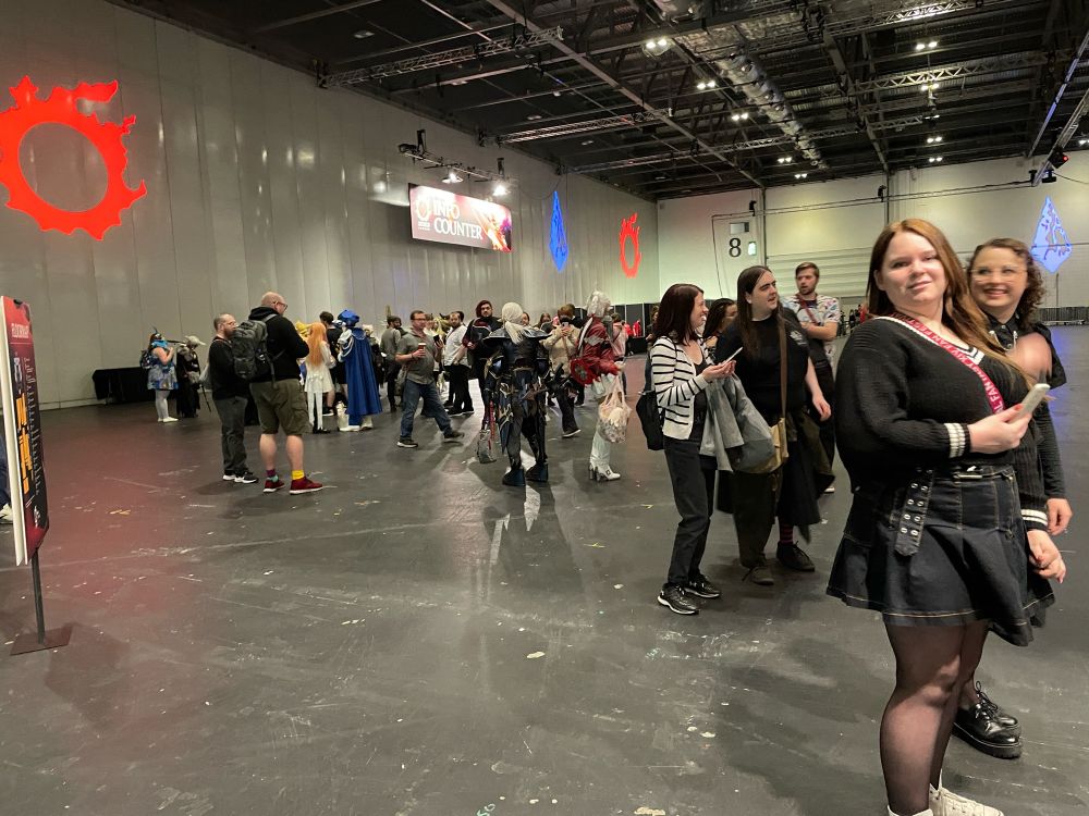 View of the crowd at the information desk with cosplayers of scions and other characters