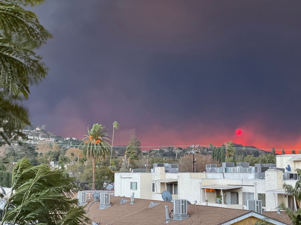 Smoke on the horizon of Glendale, CA has tinted the rising sun bright red
