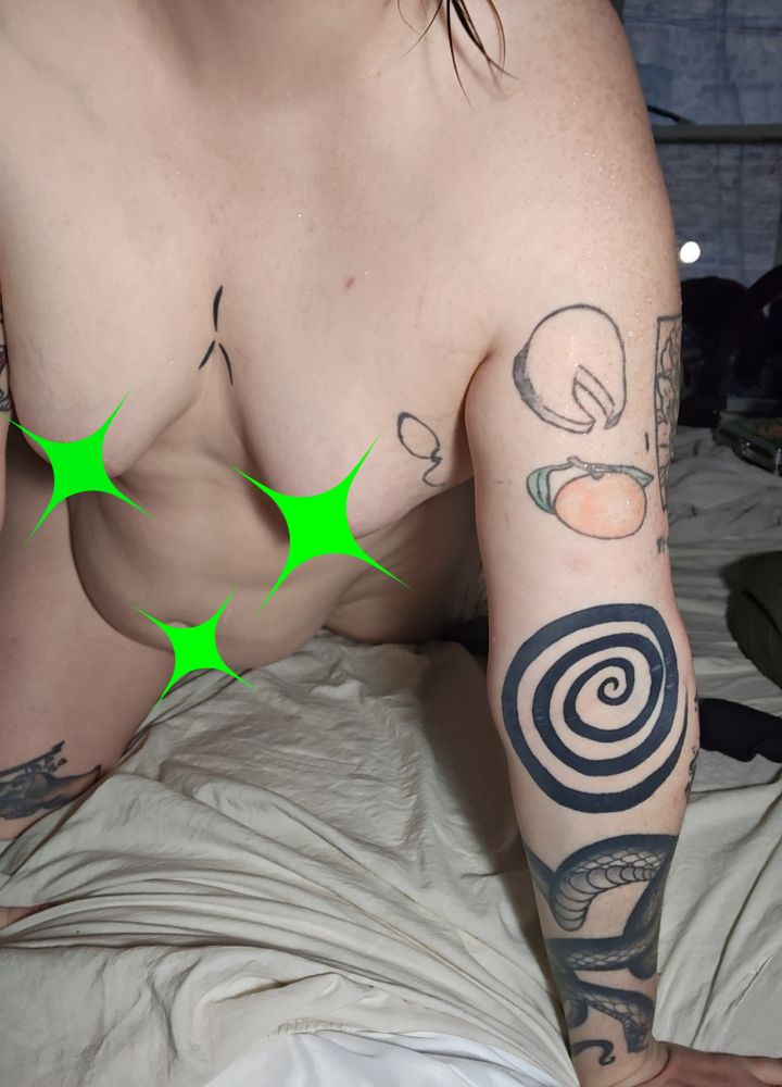 Taylor on all fours facing the camera. She is a tattood transsexual 