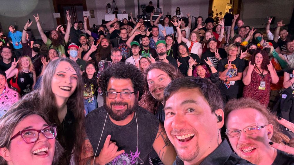 Band on stage taking a selfie