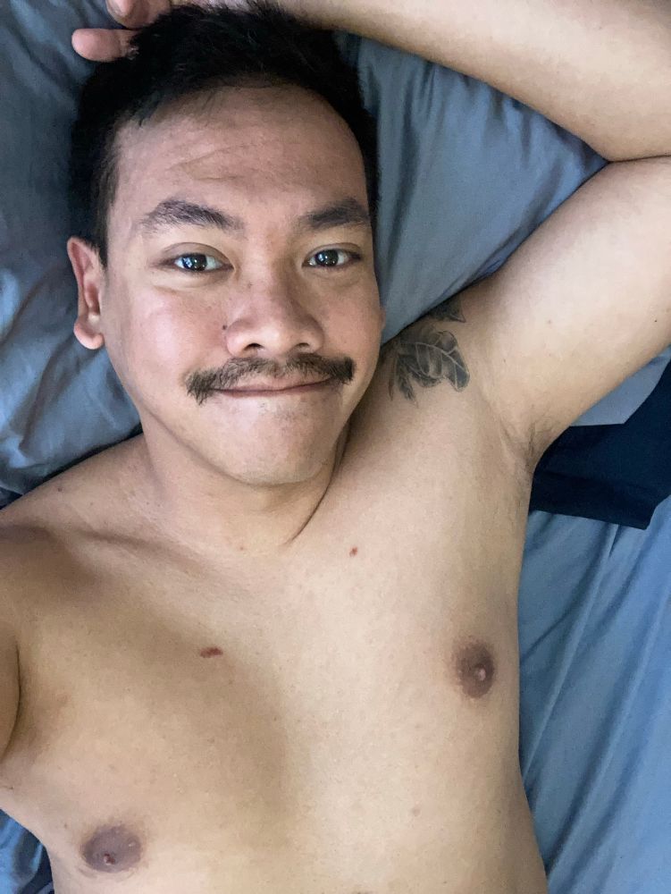 Me lying in bed naked. You can see my face, my pits, the tattoo on my shoulder, and my chest.