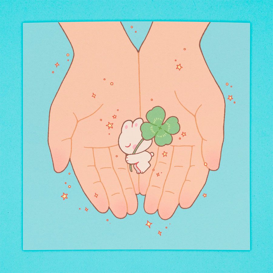 Art print depicting a cupped pair of hands showing off a small, sleeping bunny carrying a four-leaf clover.