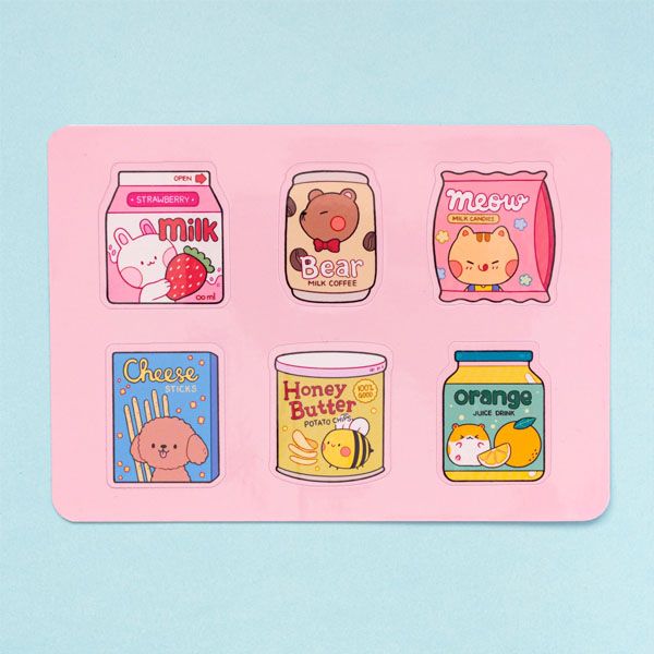 Sticker sheet featuring six snack-themed designs. The top row shows a strawberry milk carton, a coffee can, and a bag of candies. The bottom row shows a box of cheese sticks, a can of honey butter chips, and a bottle of orange juice.