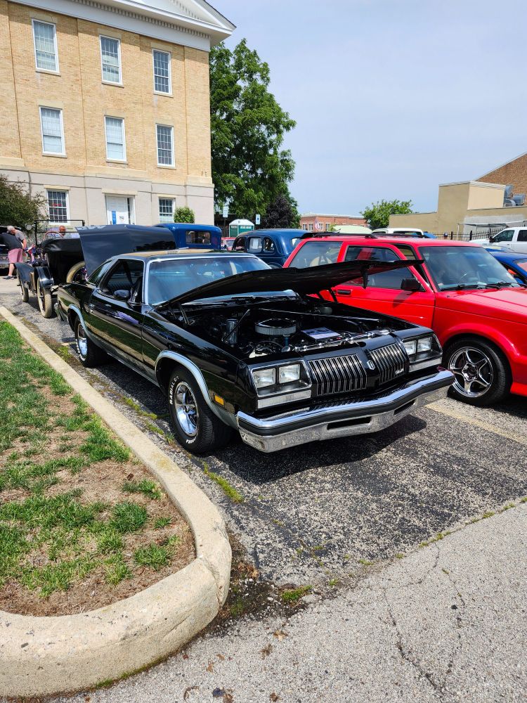 Shiny black 1970s Oldsmobile Cutlass at a car show