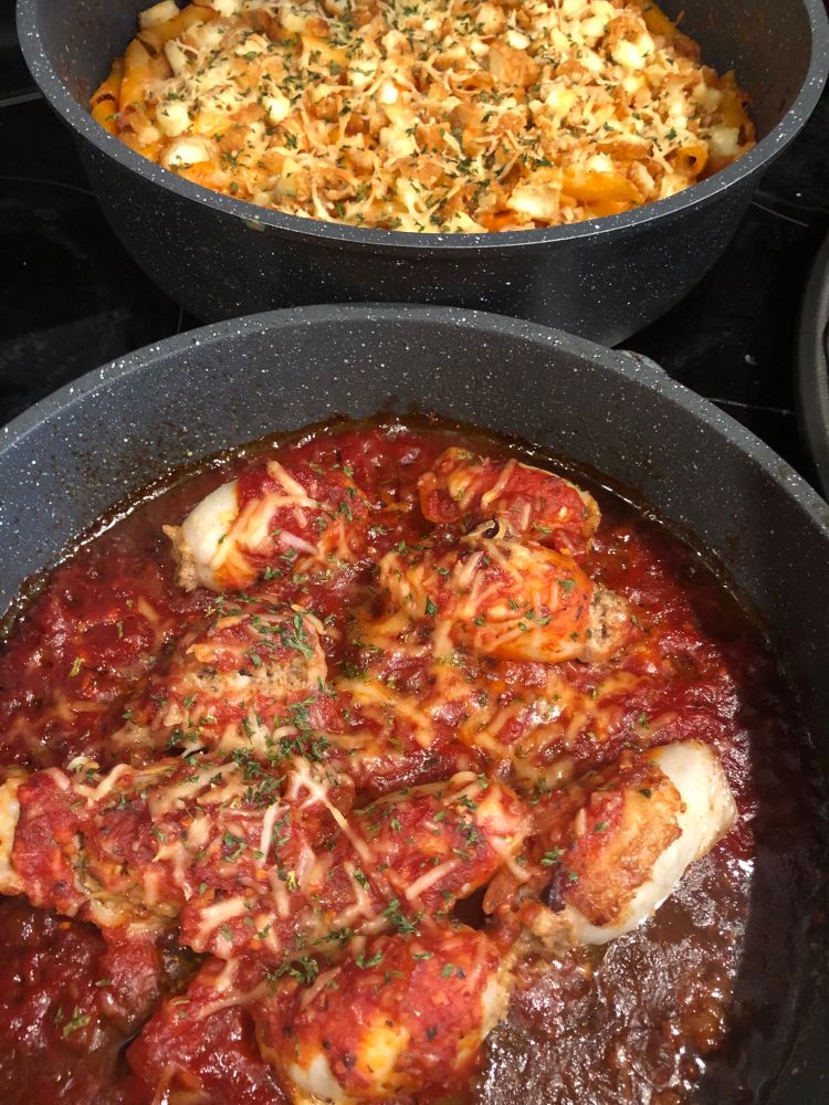 Stuffed calamari in the foreground. Baked ziti behind it. 