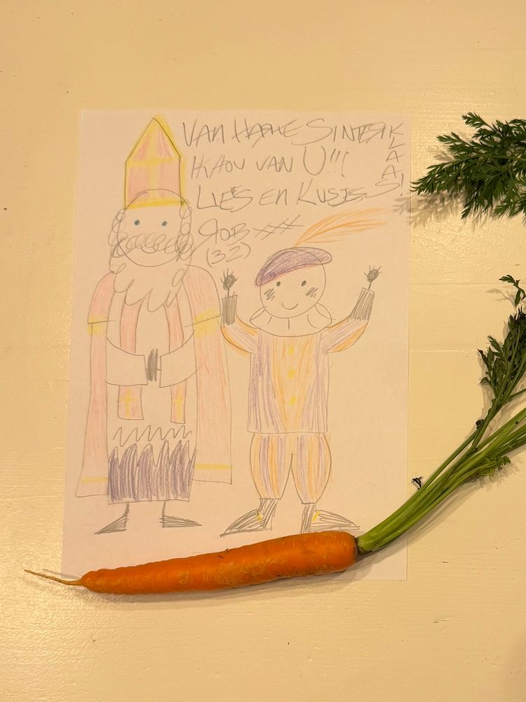 A drawing of St. Nicholas and his helper Piet, which I made in the style of a child, with the message “Van harte Sinterklaas! Ik hou van u!!! Liefs en kusjes, Rob xxx (32)” (Happy birthday St. Nicholas! I love you!!! Love and kisses, Rob xxx (32)” with a carrot for his horse, Ozosnel.  