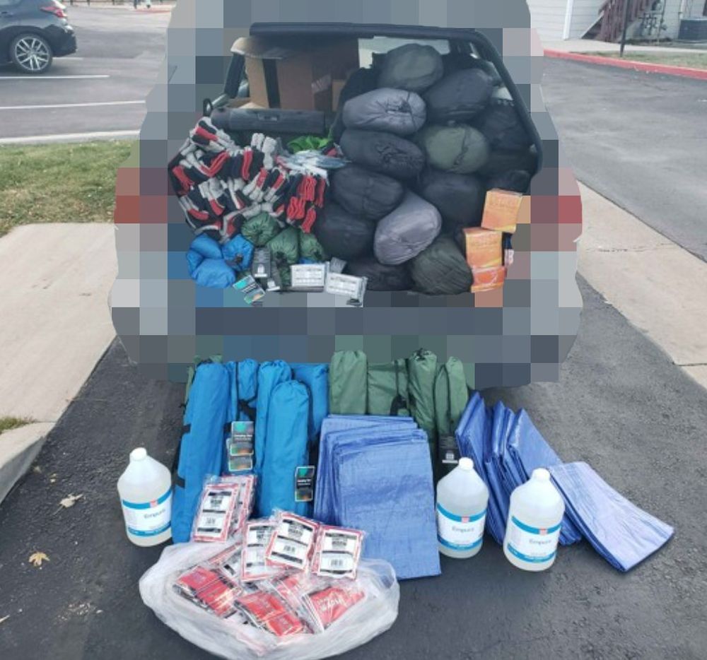 A car full of sleeping bags, tents, socks, handwarmers, tarps. The car is pixelated for anonymity.
