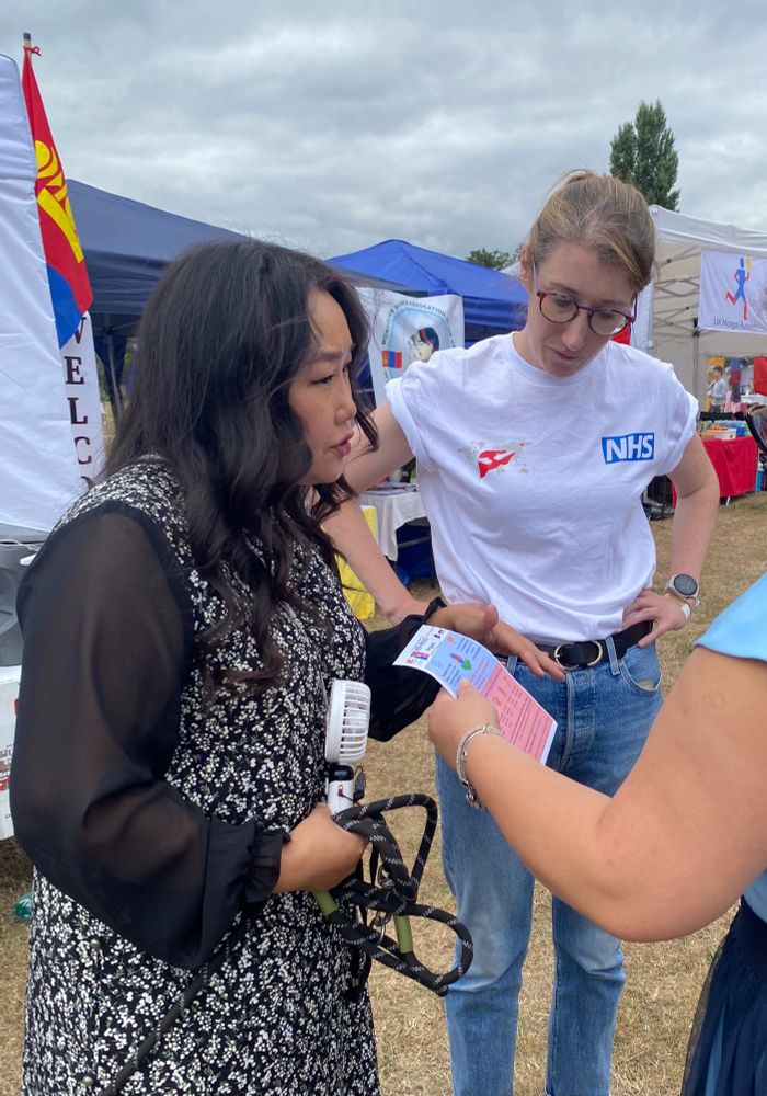 Team members discuss liver health and provide information for a visitor to our stand