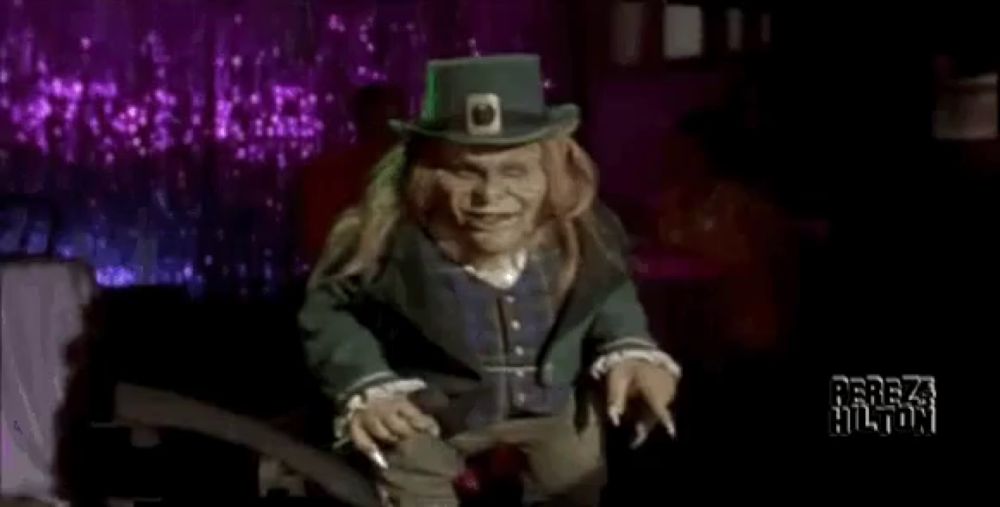 a leprechaun is holding a microphone in his hand and singing into it .