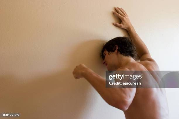 stock image of a dude punching a wall in despair