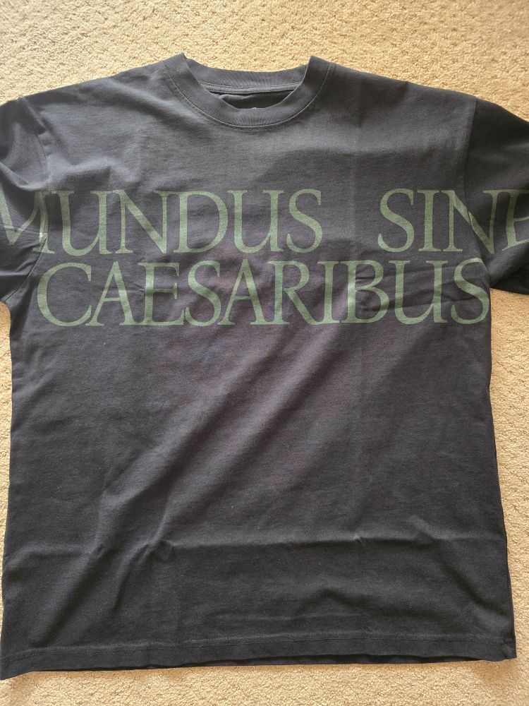 Black T shirt that reads "Mundus Sine Caesaribus" which translates to "a World without Caesars"