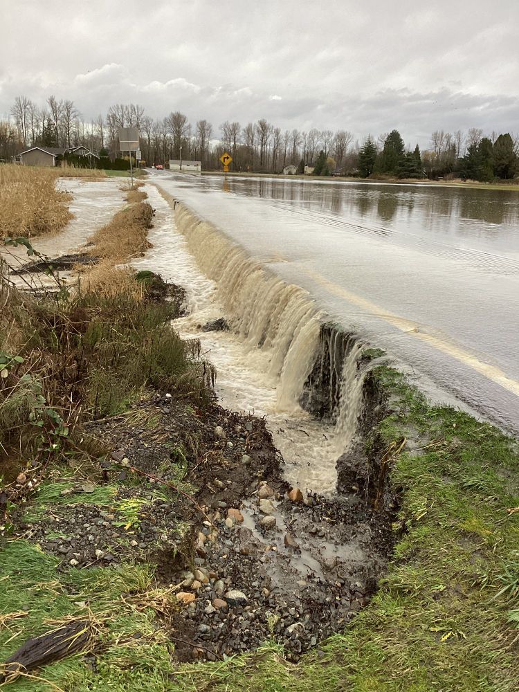 Image shows water spilling over State Route 9 in Everson.