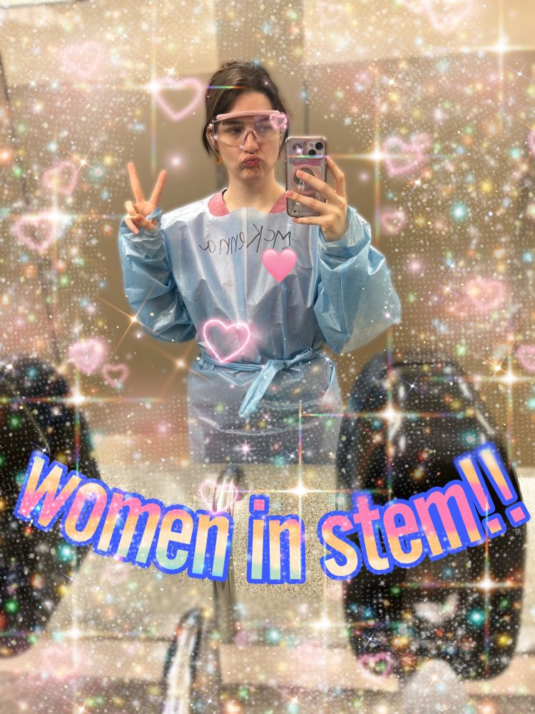 A photo of me in my anatomy lab gown with the words “women in stem!!” And glitter and hearts everywhere 