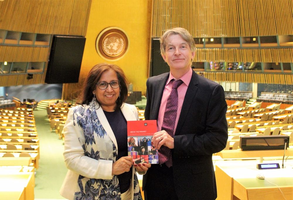 Conor Gearty and Purna Sen holding the report ‘Above the Parapet’ in the UN General Assembly room in New York. 
