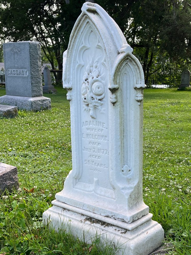 A beautiful white headstone, gothic style. 