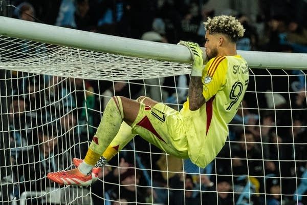 Dayne St. Clair kissing the goal.