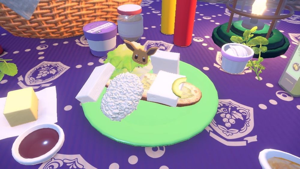 A pokemon Scarlet sandwich on a plate with ingredients scattered everywhere.  There is an eevee toothpick placed in it as well.