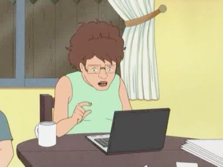 Peggy from King of the Hill is looking g at a laptop.  Her face reads as very befuddled.