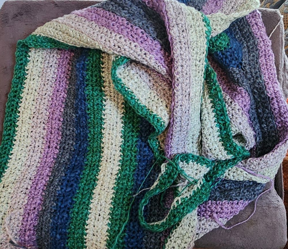 Pile of crochet stripes in pastel mint, teal, cobalt, denim, and two shades of lavender