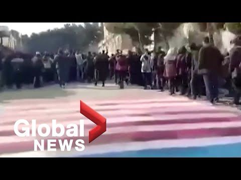 Iranian students avoid stepping on images of U.S., Israeli flags