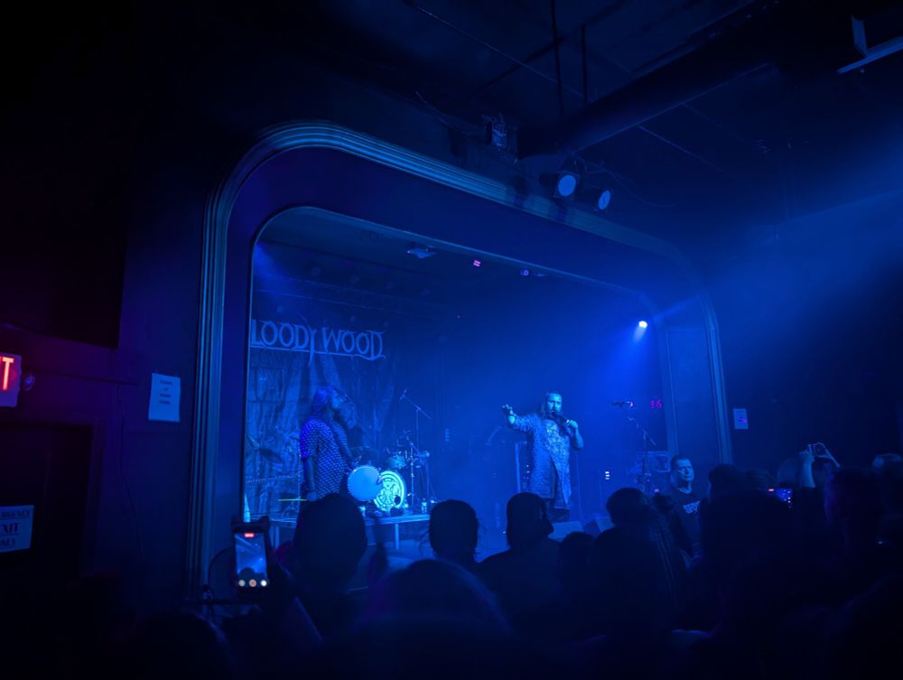 Stage lit up blue with the band members of Bloodywood.