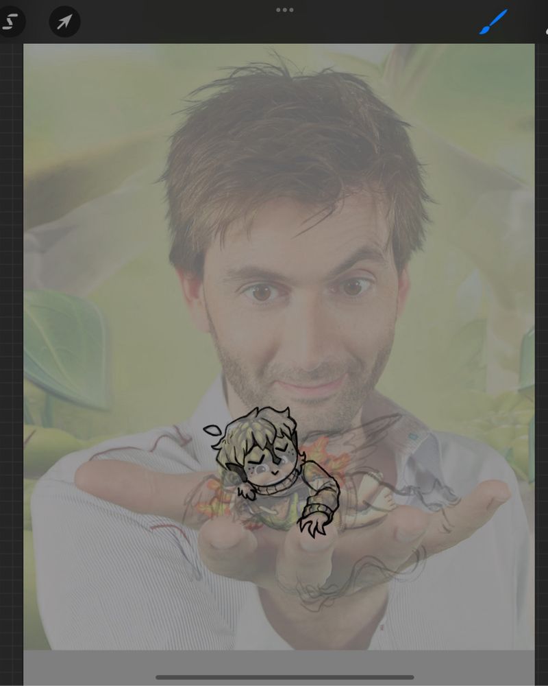 A picture of David Tennant holding MattiBird’s little oc creature in the palm of his hand. Very cute and very awesome.