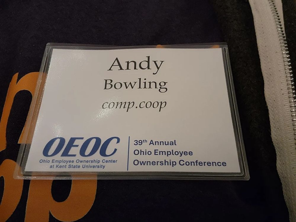 Andy's badge at OEOC, listing his name and our company name. 