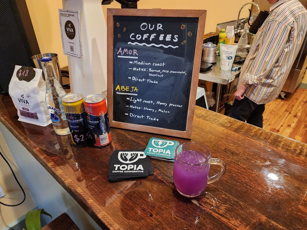 The menu at Topia. It's divided into 2 types of coffee: amor and abeja. 

Amor: medium roast with hints of berries, chocolate, and hazelnut.

Abeja: light roast with hints of honey and melon.

Both coffees are marked as Direct Trade.