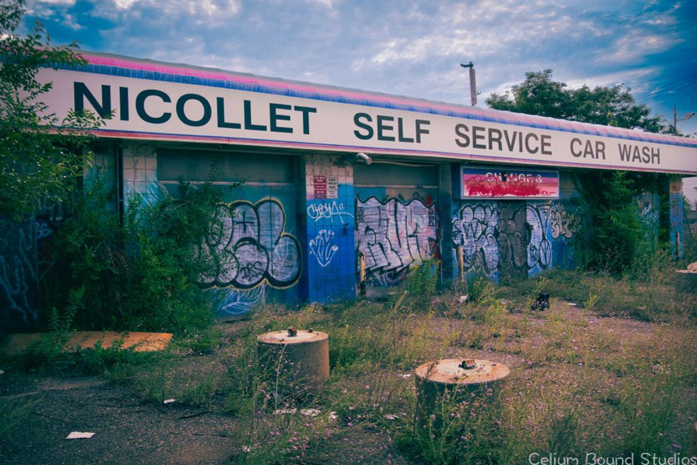 The abandoned Nicollet self service car wash. The garage doors are covered in graffiti, and the parking lot is filled with weeds growing through the cracks. I swear when I took this picture I heard music coming from inside this building...