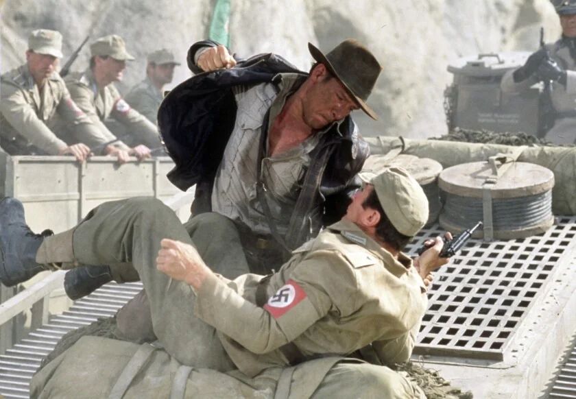 A picture of Harrison Ford as Indiana Jones beating the shit out of a Nazi 
