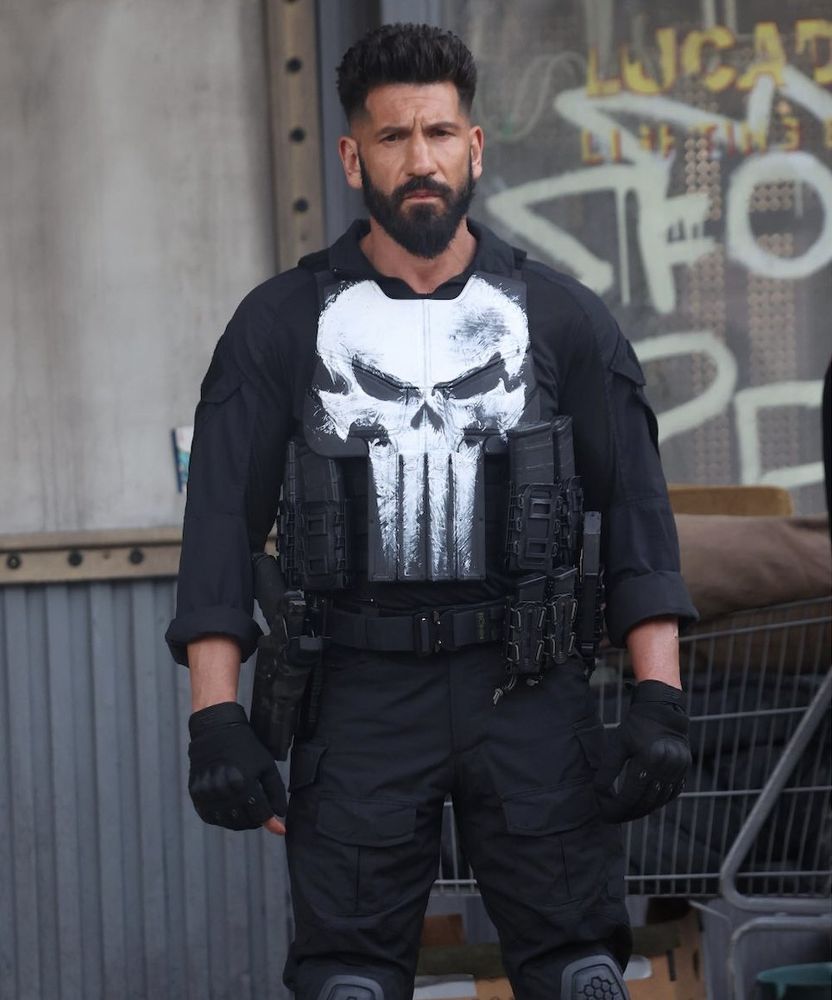 photo of jon bernthal's punisher on the set of i think his special or something?? i forget. but his neutral stance and slightly plussed face is giving toddler kinda.