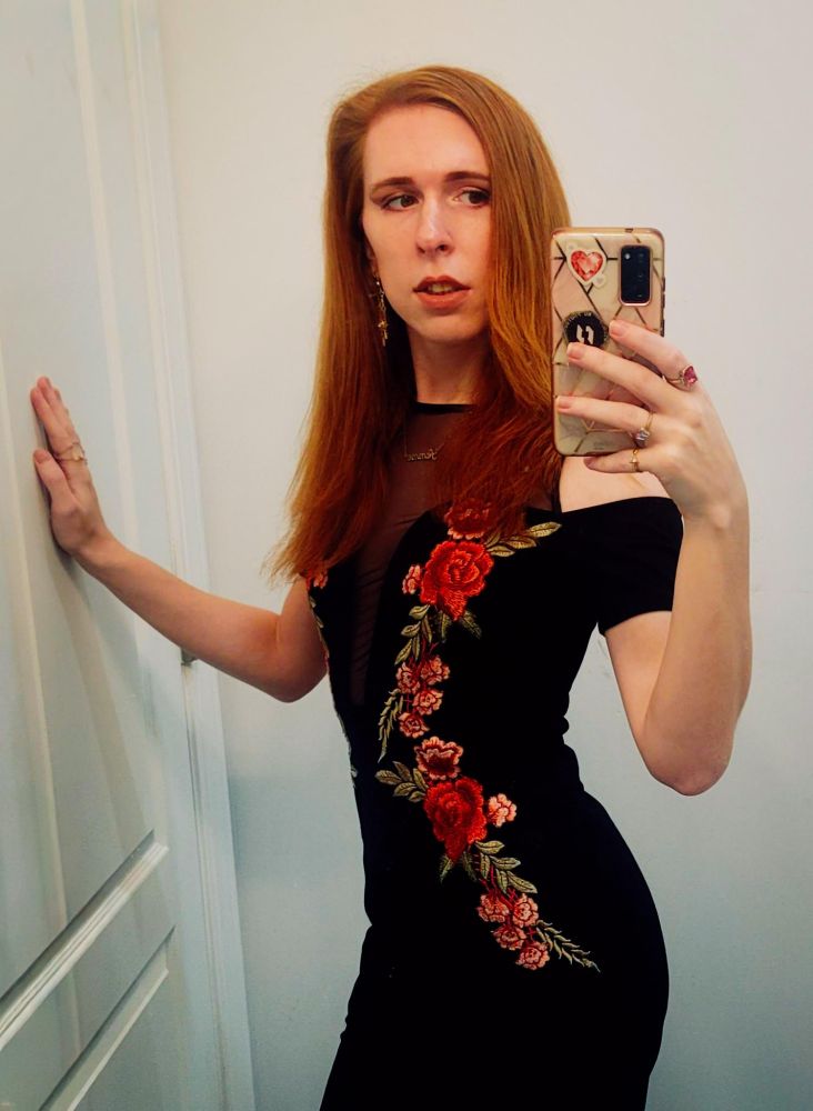 krystal swords in a black dress with floral patterns