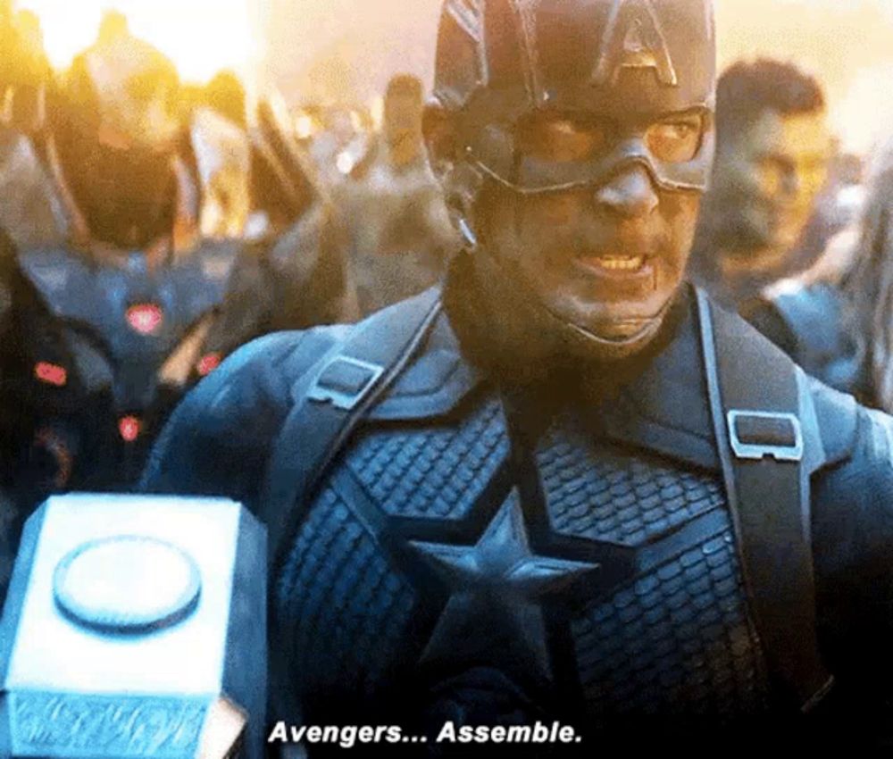 captain america is holding a hammer and says avengers assemble