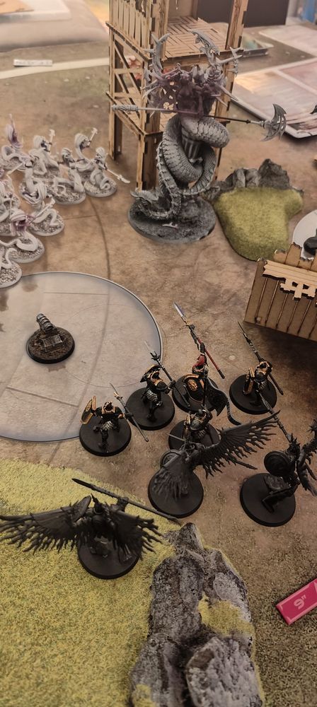 Image of a game of Warhammer Age of Sigmar.

Stormcast Eternals (bottom half of image ) face an incoming attack from some Daughters of Khaine (top half of image) 