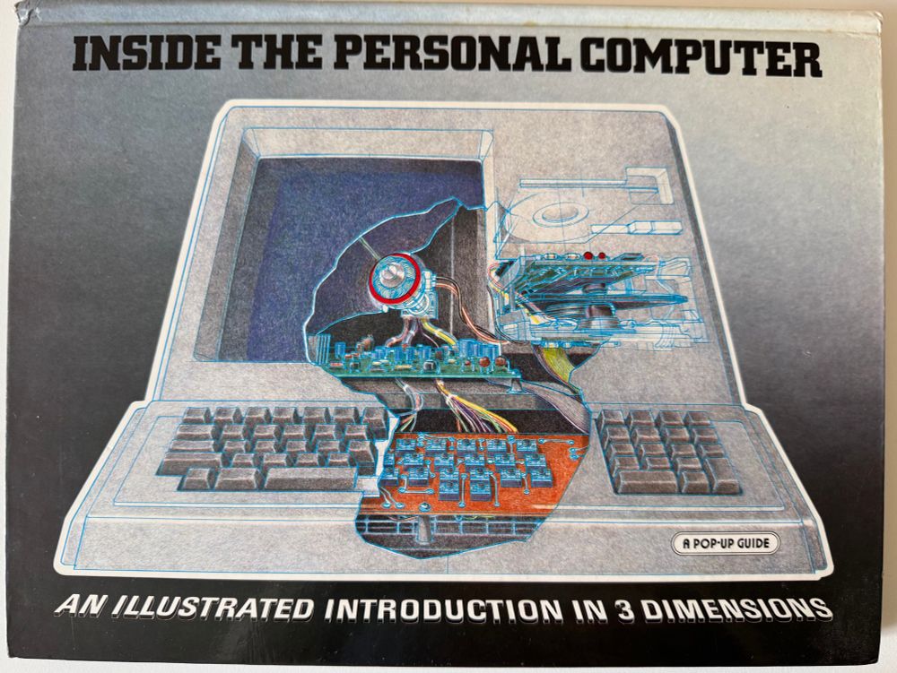 Front cover of the book Inside the Personal Computer - An Illustrated Introduction in 3 Dimensions.
It’s mostly blueish grey with a drawing of a desktop computer typical of the time. In the middle we can see the colourful inside of the keyboard, monitor, hard disk drive, and floppy drive.