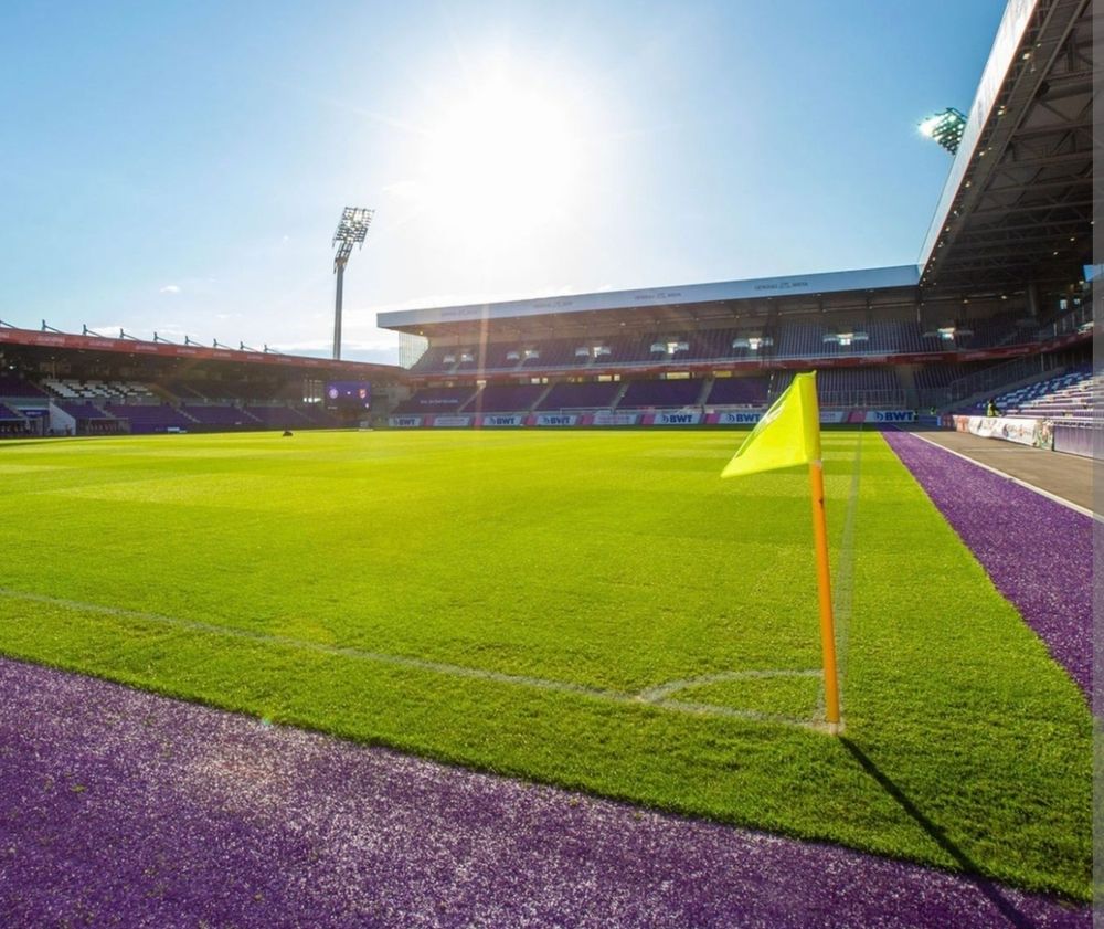 The Viola Park stadium, with a blue sky and the sun shining on the turf.