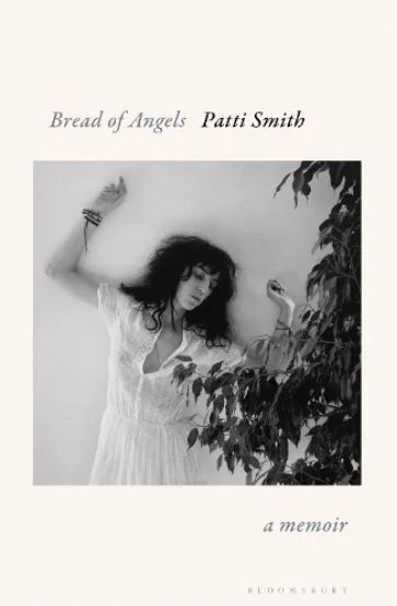 front cover of Patti Smith memoir "Bread of Angels" - a Robert Mapplethorpe photo of Smith taken in 1978 or so with her in a white dress against a wall