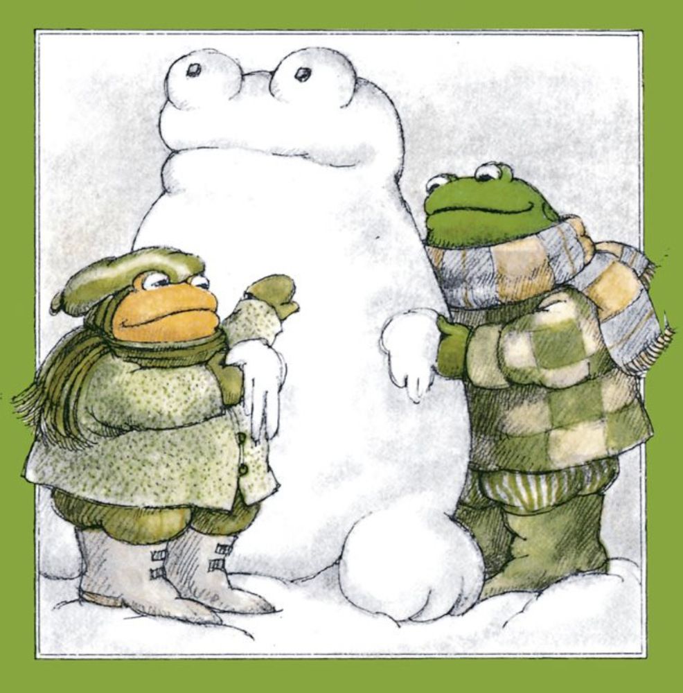 Frog and Toad, all bundled up, put the finishing touches on a snowman. Er. Snowfrog.

From "Down the Hill"
In *Frog and Toad All Year*