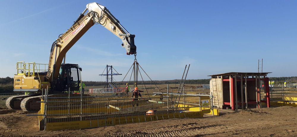 Lowering temporary bracing into the station box excavation