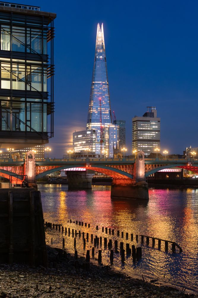 View of the River Thames at dusk with modern buildings in the distance
