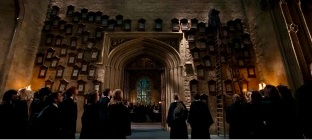Image shows scene in Harry Potter movie of all of Dolores Umbridge’s proclamations on the walls of Hogwarts