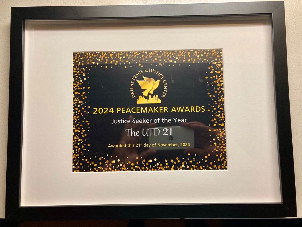 A framed certificate from the Dallas Peace & Justice Center that names the UTD 21 as "Justice Seeker of the Year" for 2024. 