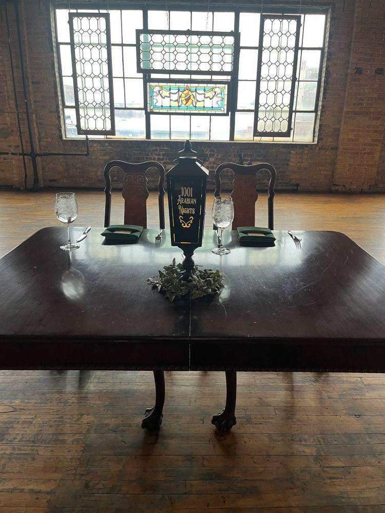 A table setting with a lantern on it.