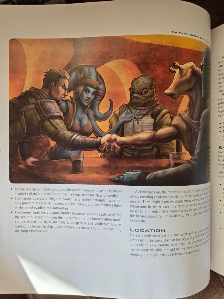 Ilustração de uma página do Star Wars Roleplaying Game: Scum and Villainy. A arte central mostra um grupo de quatro personagens de diferentes espécies ao redor de uma mesa, selando um acordo com um aperto de mãos. Da esquerda para a direita, um humano em trajes militares, uma Twi'lek de pele azul, um Trandoshano e um Gungan. A cena sugere uma reunião tensa mas colaborativa, com copos sobre a mesa. Abaixo da imagem, há texto descrevendo cenários para aventuras, envolvendo trabalhos para um sindicato criminoso, caçadores de recompensas ou contrabandistas. O título "Location" inicia uma seção explicando possíveis ambientes para encontros iniciais no jogo.
