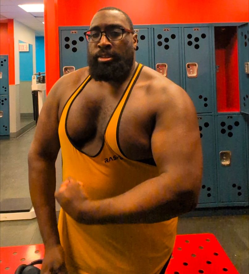 Me flexing in the gym after an upper body workout day. I'm wearing a bronze colored y back gym tank top