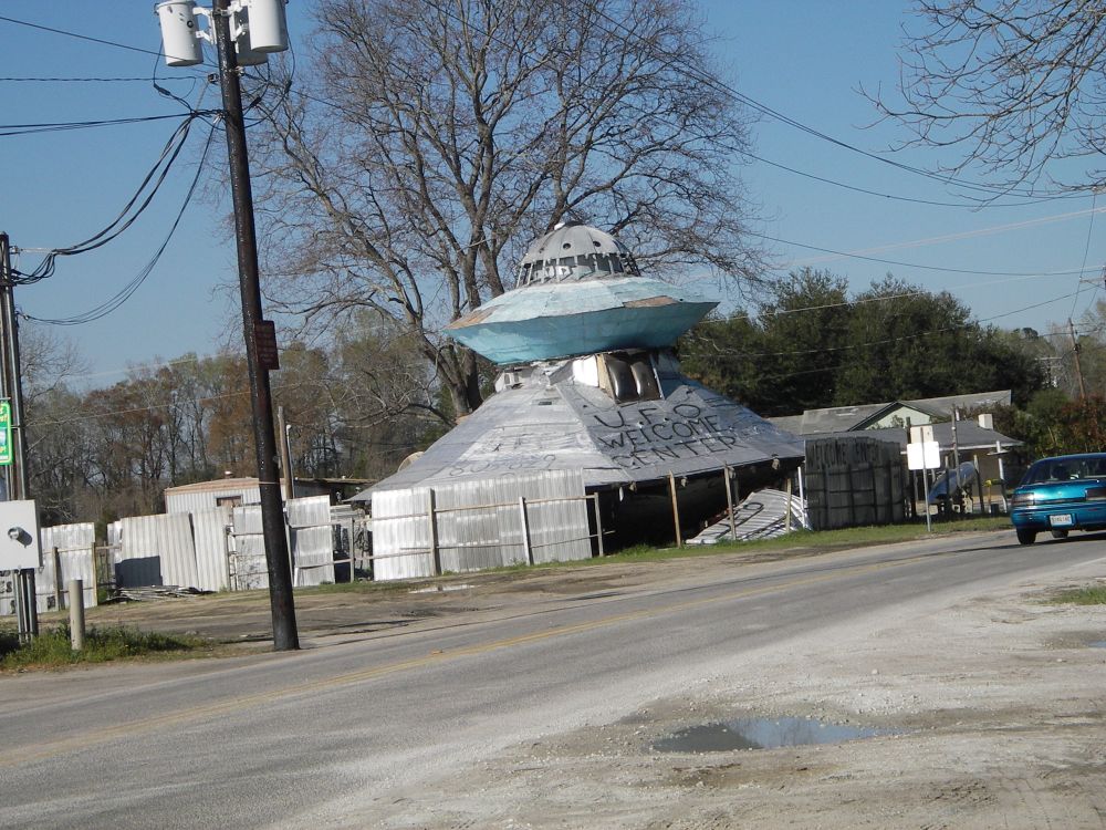 The UFO Welcome Center in Bowman, South Carolina, which has the same broad shaped and color as the Tesla cafe, but a billion times more charm. It apparently burned to the ground about the same time Elon started stealing its style for his cafe thing. COINCIDENCE???